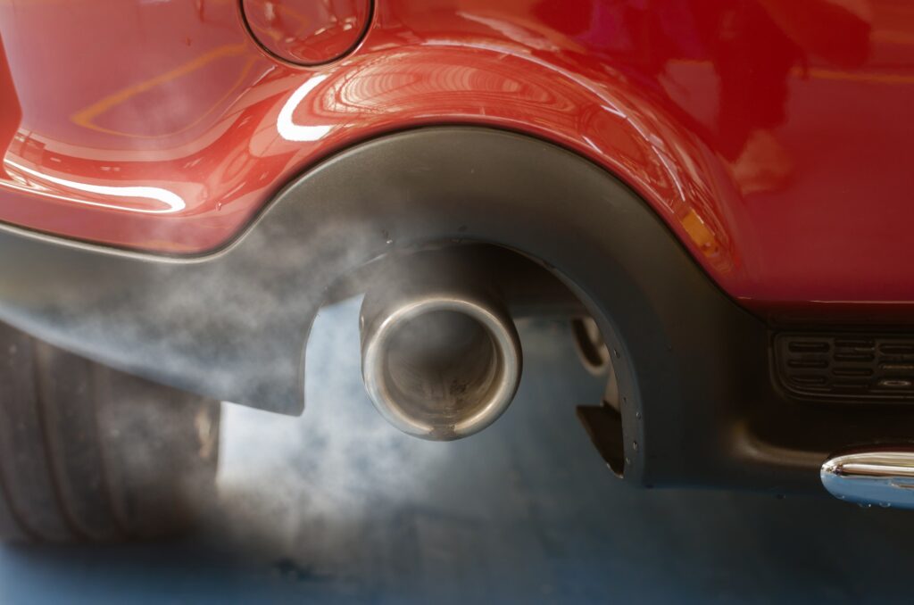 Car smog and air pollution from the exhaust pipe.