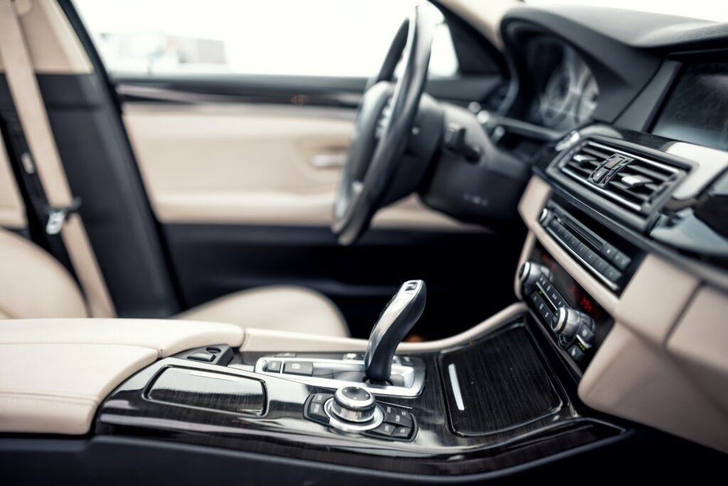 Modern beige and black interior of modern car, close-up of automatic transmission