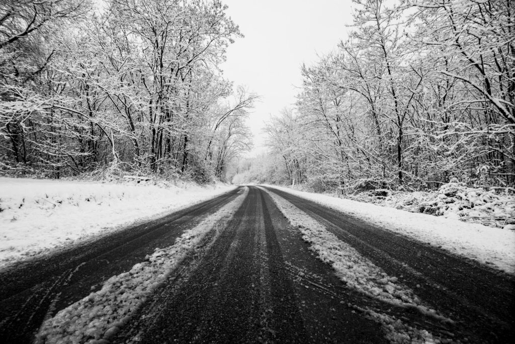 winter road with snow on the ground travel and drive concept