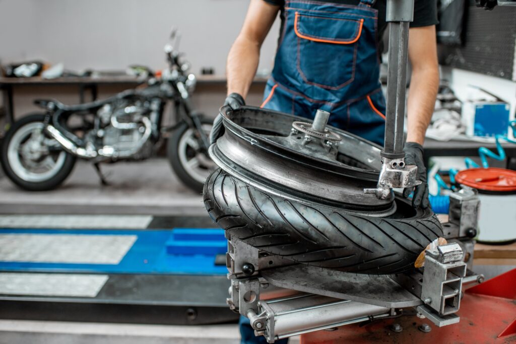 Worker changing a motorcycle tire