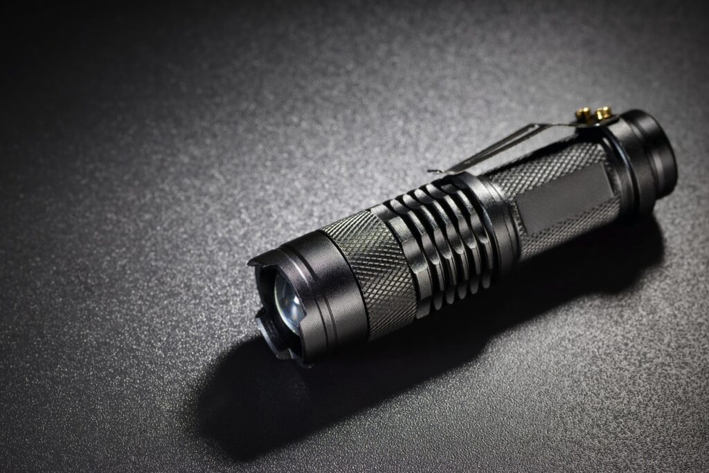 Black metallic flashlight or torch