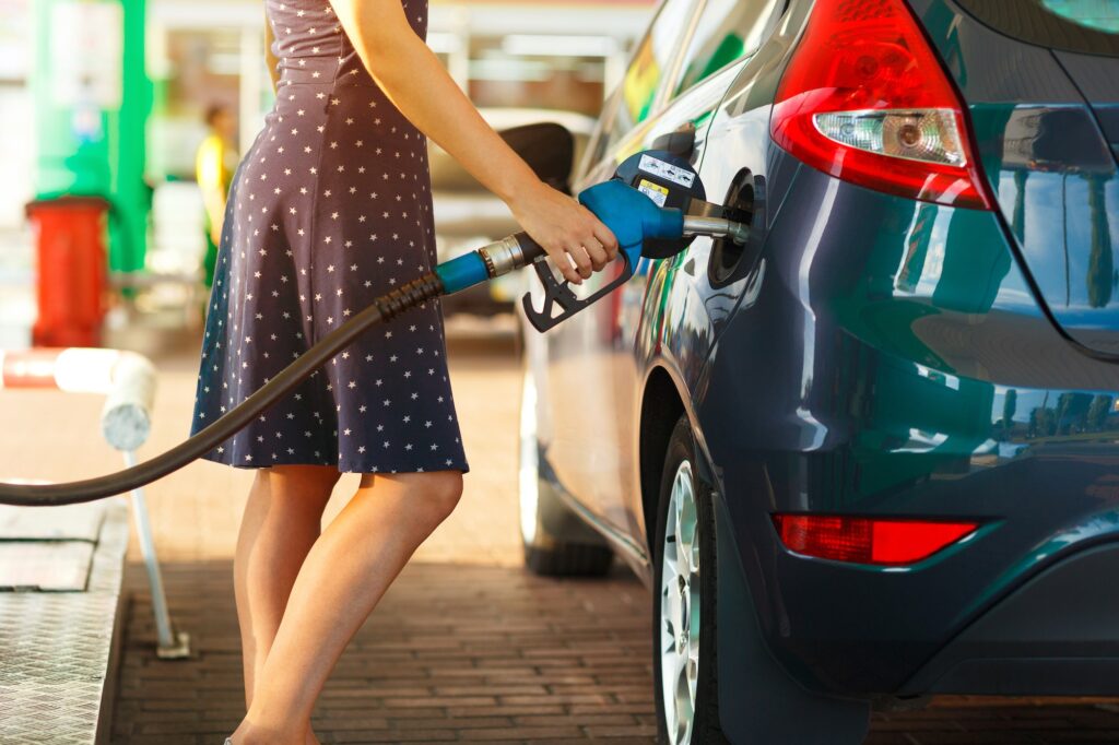 Woman fills petrol into her car