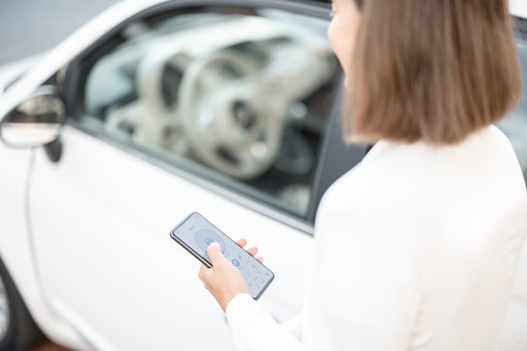 Woman control car alarm with mobile phone